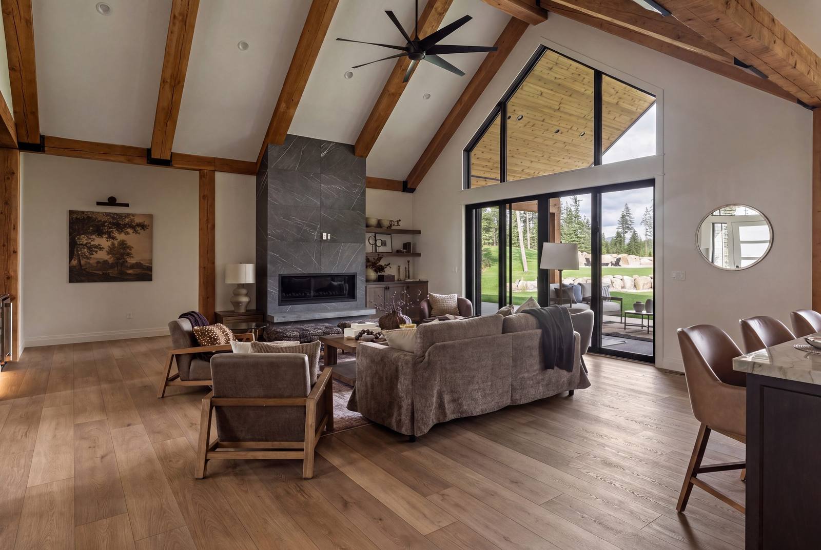 Vaulted great room with exposed timber trusses and floor-to-ceiling stone